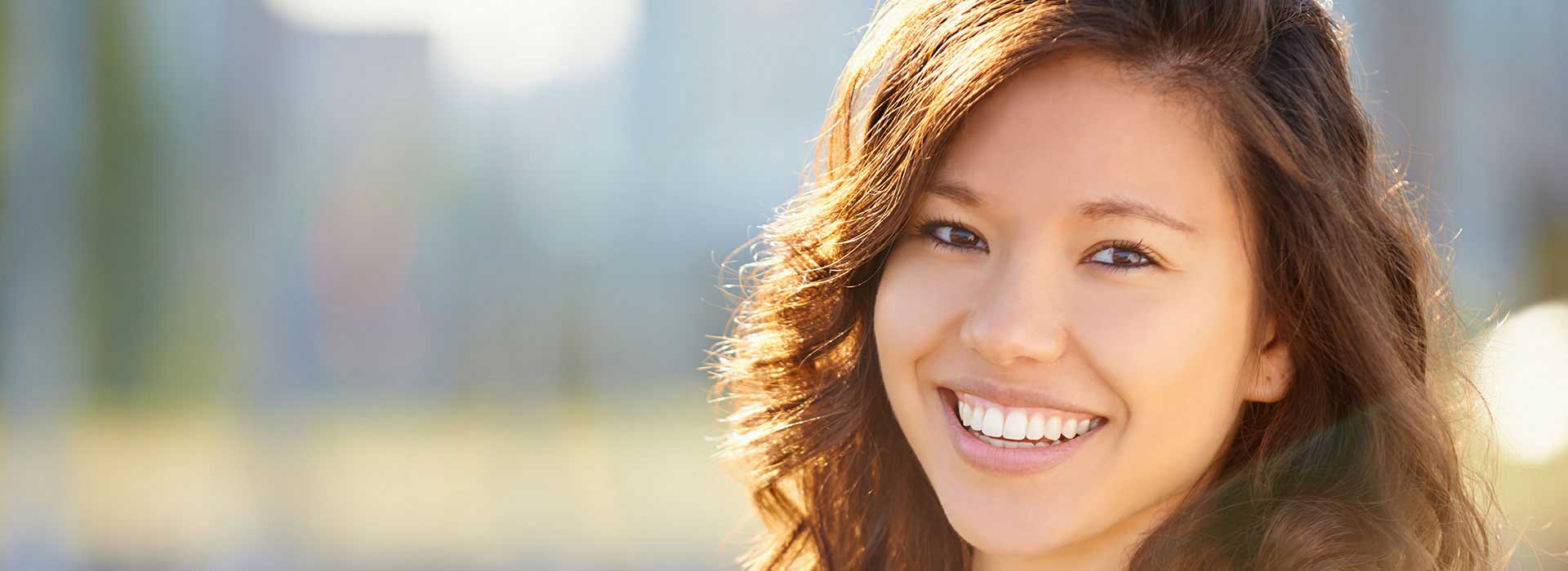 A woman with long red hair smiling for the camera.